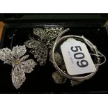 A marcasite bangle bracelet in the form of a snake, two butterfly brooches and a bow brooch
