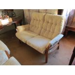 A 1990's light wood Ercol 'Seville' settee and two chairs with cream brocade fabric