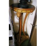 A 19th Century giltwood and gesso torchere with circular top on curved legs with lion ring tops