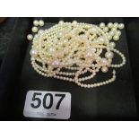A long strand of cultured pearls (in need of repair)