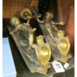 A pair of brass wall sconces cherubs