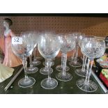 A set of eight etched wine glasses and six crystal wine glasses