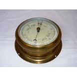 A brass cased Sestrel wall barometer measuring 8" in diameter.