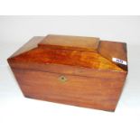 A 19th century mahogany sarcophagus shaped tea caddy with a fitted interior including original