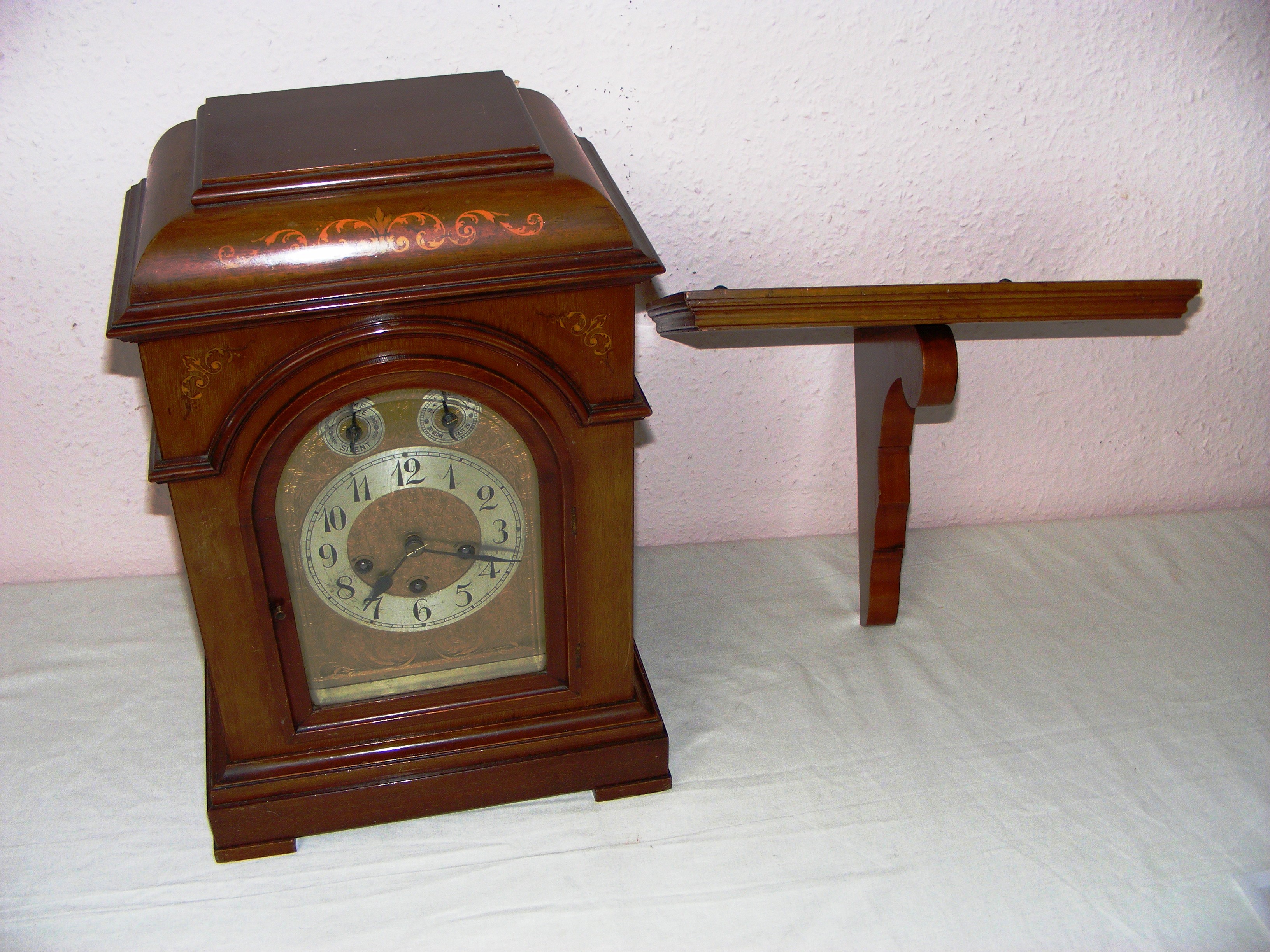 A Junghans B10 movement quarter Westminster chime mahogany cased bracket clock measuring 17" tall.