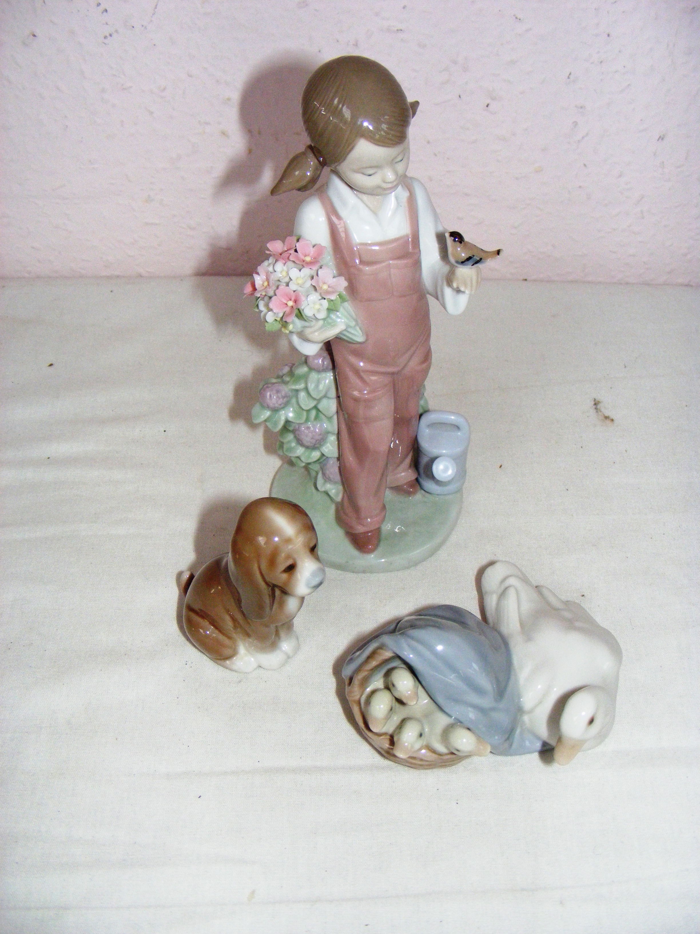 A Lladro figurine of a girl in a dress with head scarf 21.