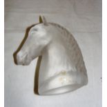 A decorative frosted paperweight in the form of a horse's head,