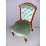 A Victorian green upholstered nursing chair measuring 20" wide.