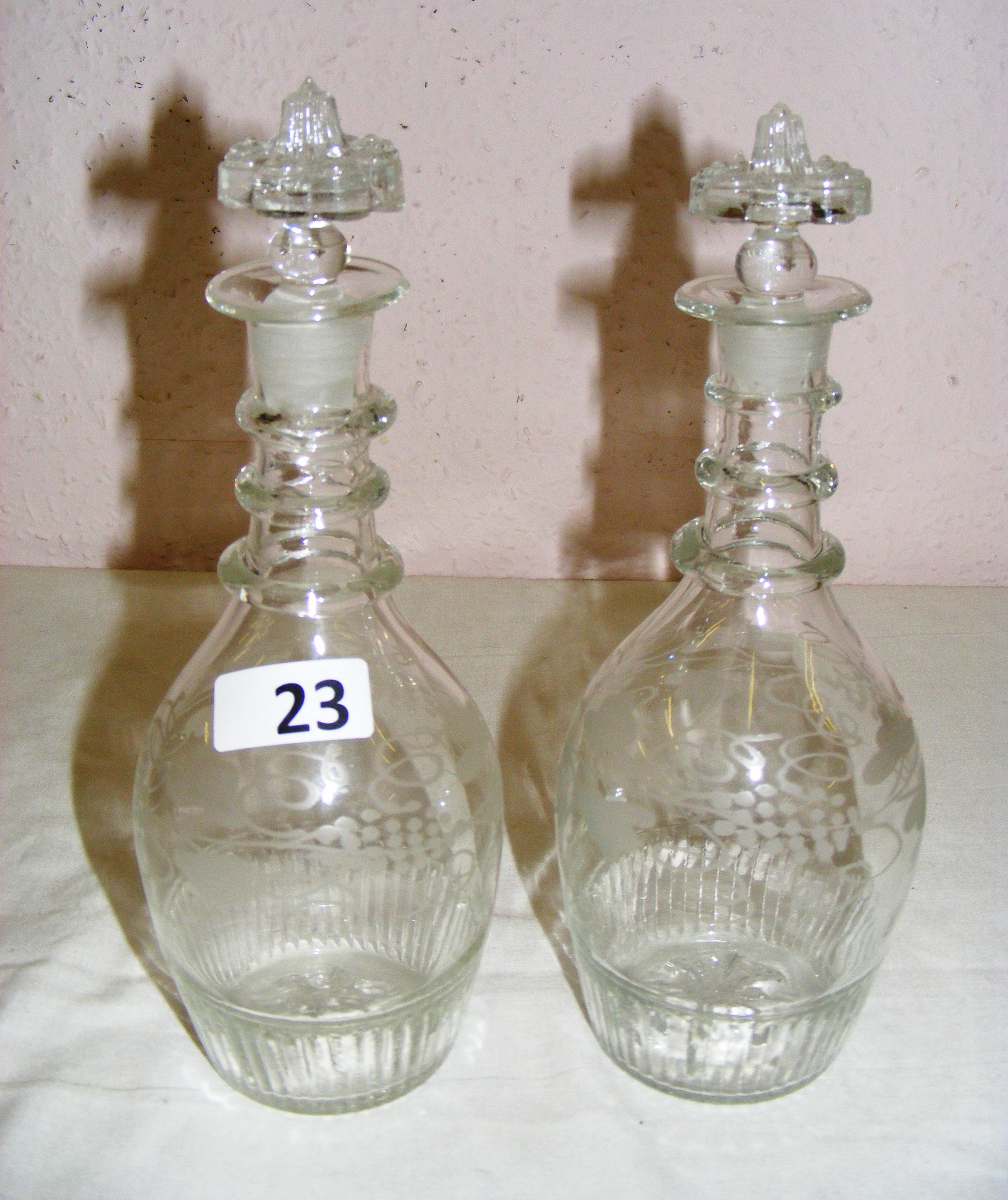 A pair of triple ring Georgian decanters with etched decoration and each standing at 9.