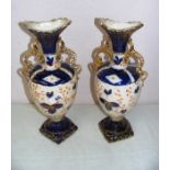 A pair of Edwardian twin handled porcelain vases each measuring 14" tall.