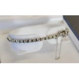 A 14ct. White Gold Baguette and Round Brilliant Cut Diamond Line Bracelet, approximately 1.