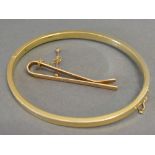 A 9ct. Gold Bangle together with a 9ct. Gold Tie Clip, 12.