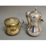 A Continental White Metal 800 Mark Hot Water Pot, together with a similar covered jug,