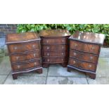 A Pair of Reproduction Mahogany Line Inlaid Serpentine Bedside Chests with three drawers together