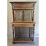 An Oak Cabinet on Stand, the moulded cornice above two carved doors flanked by turned pilasters,