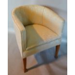 An Early 20th Century Tub Shaped Chair with an upholstered back and seat raised upon square