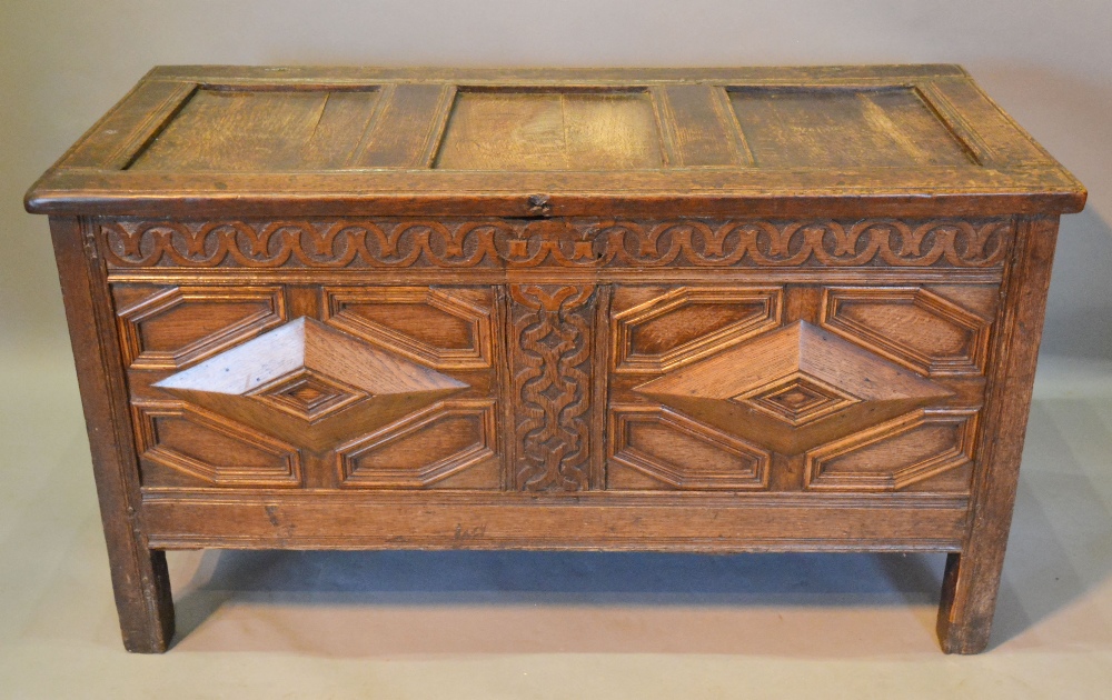 A George III Oak Coffer, the hinged top above a moulded double panel front flanked by stiles,