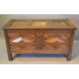 A George III Oak Coffer, the hinged top above a moulded double panel front flanked by stiles,