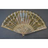 A Fine Gilt Metal Leafed Fan with a hand painted cartouche depicting a lady with fan, signed,