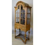 A Queen Anne Style Walnut Dome Cabinet, with two arched glazed doors enclosing shelves,