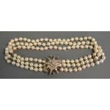 A Three Row Cultured Pearl Necklet with large 15ct.