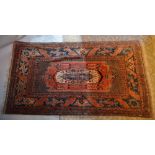 A North West Persian Woollen Rug with a central medallion within an all over design upon a blue and