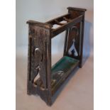 An Oak Stick Stand in the style of Liberty with Pierced Ends and Rectangular Drip Tray,