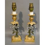 A Pair of French Patinated Bronze and Ormolu Table Lamps with facet cut glass drops,