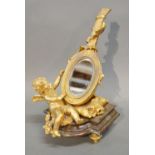 A French Ormolu and Variegated Marble Table Mirror in the form of a Mandolin with Putti Surmount