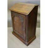 A 19th Century French Clerk's Desk, the hinged top above a moulded door raised upon a plinth,