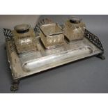 An Edwardian Silver Ink Stand of Pierced Form with two cut glass and silver mounted bottles,