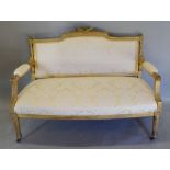 A Late 19th Early 20th Century French Gilded Salon Sofa with an upholstered back and seat with