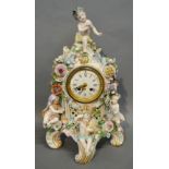 A 19th Century German Porcelain Table Clock with Putti Surmount amongst Foliage,