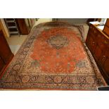 A North West Persian Style Woollen Carpet with a central medallion within an all over design upon a