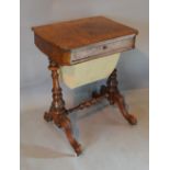 A Victorian Burr Walnut Work Table with a frieze drawer above a fabric wool box raised upon twin