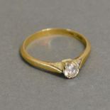 An 18ct. Gold and Platinum Solitaire Dia