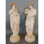 A Pair of Large Bisque Figures of Classical Females each upon a circular pedestal base and