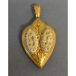 A Late 19th Early 20th Century High Grade Gold Pendant of Shaped Form set with two carved ivory oval