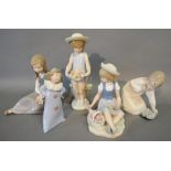 A Lladro Porcelain Model of a Girl with Flowers, together with three other Lladro porcelain models