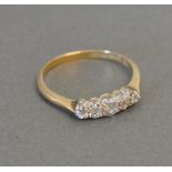 An 18ct. Yellow Gold and Platinum Five Stone Diamond Ring set with five graduating diamonds within a