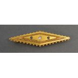 A 15ct. Gold Brooch of Lozenge Form, set with a central diamond flanked by sapphires, 4.9 gms