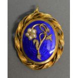 A Victorian Oval Gold Mourning Brooch, the oval blue enamel panel set foliate spray with pearls