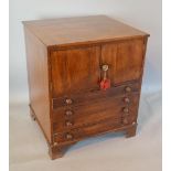 A 19th Century Mahogany Nightstand with two doors above four long drawers with knob handles raised