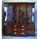 A Mahogany Break Front Bookcase, the moulded cornice above four astragal glazed doors enclosing