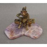 A Patinated Bronze Model in the form of a Monkey upon a Seat upon shaped hardstone stand, 4.5 cms