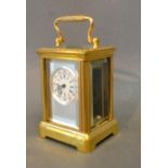 A Brass Cased Miniature Carriage Clock, the silver face with circular enamel dial and carrying