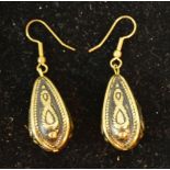 A Pair of Yellow Metal Earrings of Teardrop Form with engraved decoration