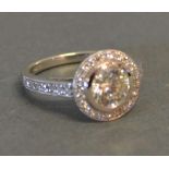 An 18ct. White Gold Diamond Halo Style Solitaire Ring, the central diamond approximately 1.06 ct.