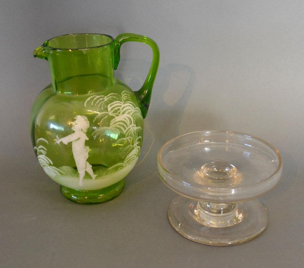 A Mary Gregory Style Green Glass Jug, decorated with a Boy amongst Foliage together with a small