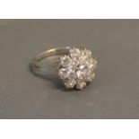 An 18ct. White Gold Diamond Cluster Ring set with seventeen round brilliant cut diamonds